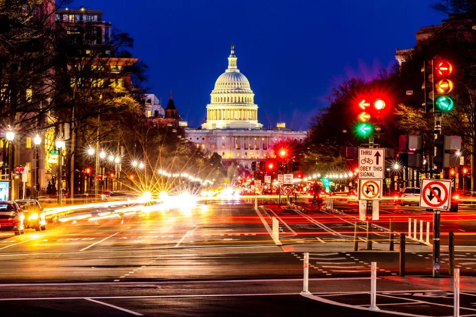 Nighttime view of U.S. Capitol and blurred traffic on Pennsylvania Avenue